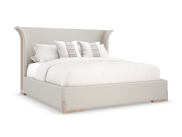 bed with softly flared headboard shape